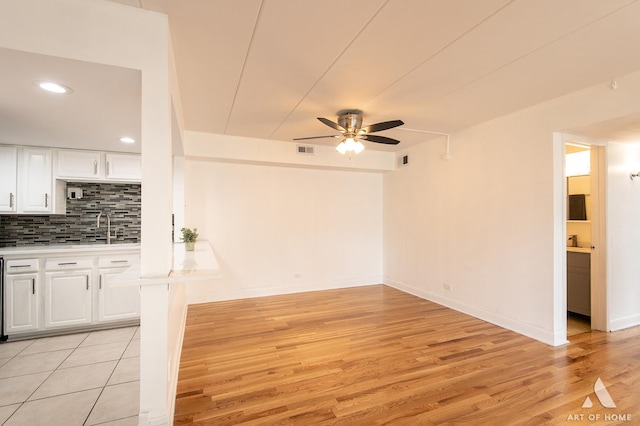 9146 W 140th St Unit 2Sw, Orland Park, IL 60462 - unfurnished living room featuring a ceiling fan, light wood-style floors, recessed lighting, baseboards, and a sink