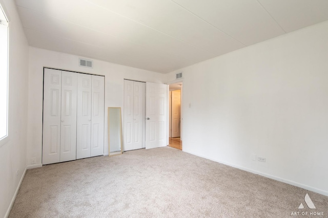 9146 W 140th St Unit 2Sw, Orland Park, IL 60462 - unfurnished bedroom featuring multiple closets, carpet flooring, and baseboards