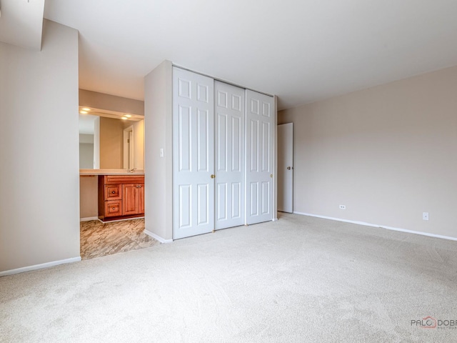 500 W Huntington Commons Rd Unit 150, Mount Prospect, IL 60056 - unfurnished bedroom featuring carpet floors, a closet, and ensuite bathroom
