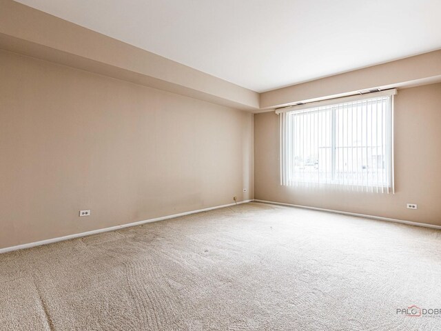 500 W Huntington Commons Rd Unit 150, Mount Prospect, IL 60056 - carpeted empty room featuring baseboards