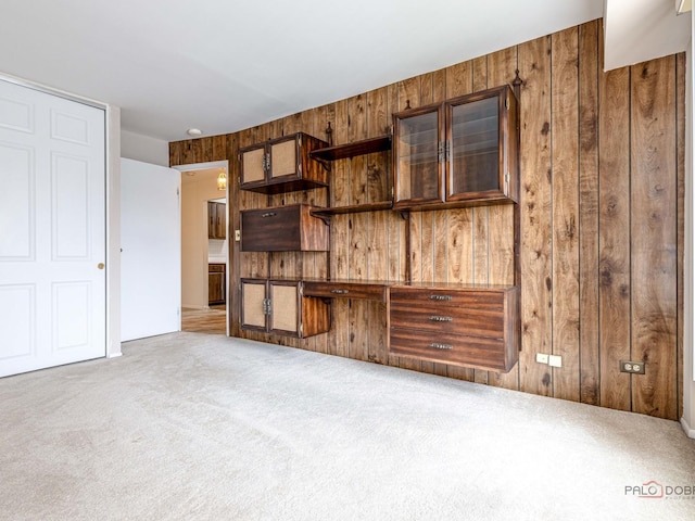 500 W Huntington Commons Rd Unit 150, Mount Prospect, IL 60056 - unfurnished living room featuring wooden walls and carpet floors