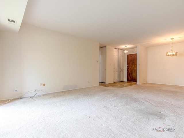 500 W Huntington Commons Rd Unit 150, Mount Prospect, IL 60056 - unfurnished room featuring a chandelier and light colored carpet