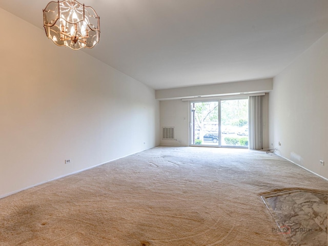 500 W Huntington Commons Rd Unit 150, Mount Prospect, IL 60056 - spare room featuring carpet and a chandelier