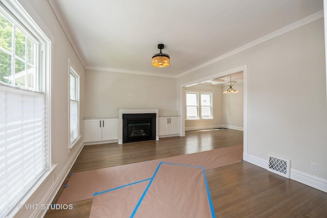 729 N Cuyler Ave, Oak Park, IL 60302 - unfurnished living room featuring dark wood-style flooring, a fireplace, ornamental molding, and a chandelier
