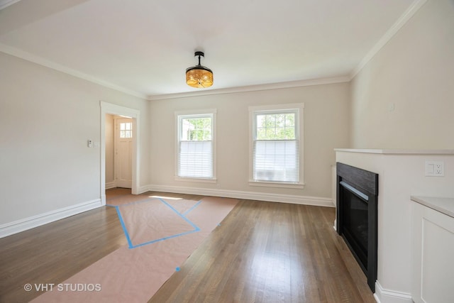 729 N Cuyler Ave, Oak Park, IL 60302 - unfurnished living room featuring healthy amount of natural light, a glass covered fireplace, wood finished floors, and ornamental molding