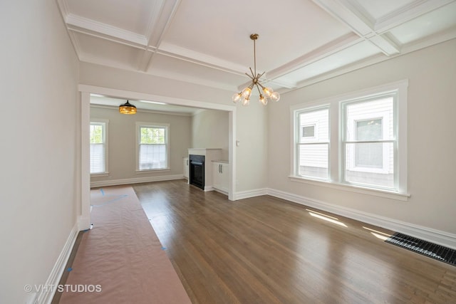 729 N Cuyler Ave, Oak Park, IL 60302 - unfurnished living room with coffered ceiling, a chandelier, dark wood-style flooring, beamed ceiling, and a glass covered fireplace