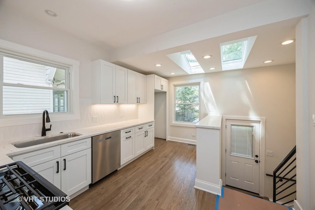 729 N Cuyler Ave, Oak Park, IL 60302 - kitchen with dishwasher, a skylight, white cabinets, wood finished floors, and light countertops