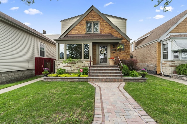 5520 S Kildare Ave, Chicago, IL 60629 - tudor house featuring a front lawn, roof with shingles, stone siding, and brick siding