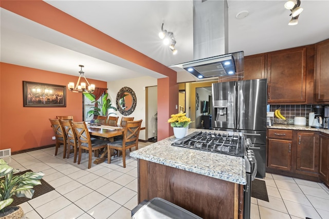 5520 S Kildare Ave, Chicago, IL 60629 - kitchen featuring stainless steel appliances, light tile patterned flooring, tasteful backsplash, a center island, and light stone counters