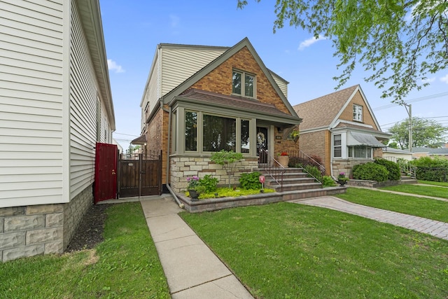 5520 S Kildare Ave, Chicago, IL 60629 - view of front of home featuring a gate, a front yard, and stone siding