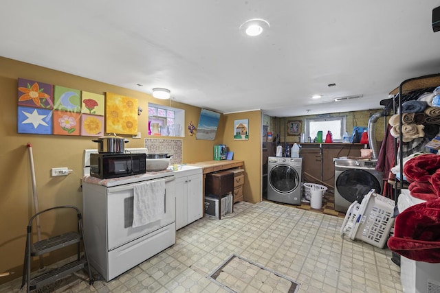 5520 S Kildare Ave, Chicago, IL 60629 - kitchen with washer and dryer, black microwave, light floors, white electric stove, and white cabinets