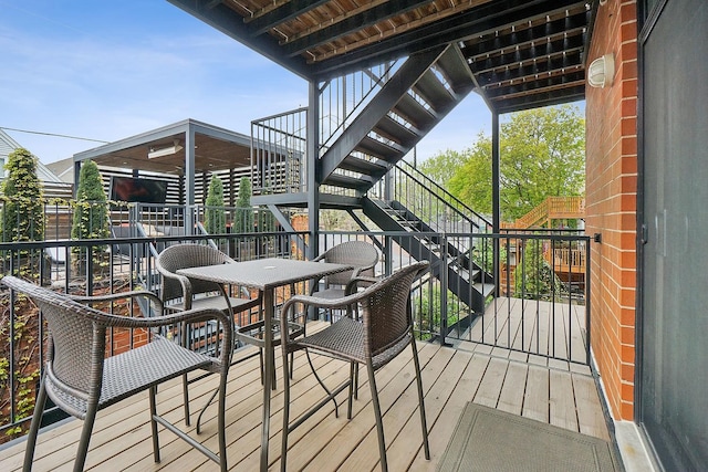 3740 N Kenmore Ave Unit 2, Chicago, IL 60613 - deck featuring stairway and outdoor dining space