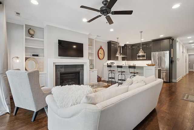 3740 N Kenmore Ave Unit 2, Chicago, IL 60613 - living room featuring a ceiling fan, a tiled fireplace, recessed lighting, baseboards, and dark wood-style floors