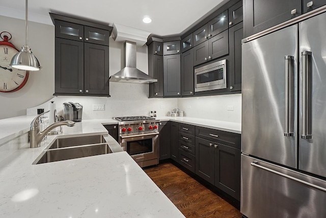 3740 N Kenmore Ave Unit 2, Chicago, IL 60613 - kitchen with high quality appliances, wall chimney range hood, a sink, light stone countertops, and dark wood finished floors