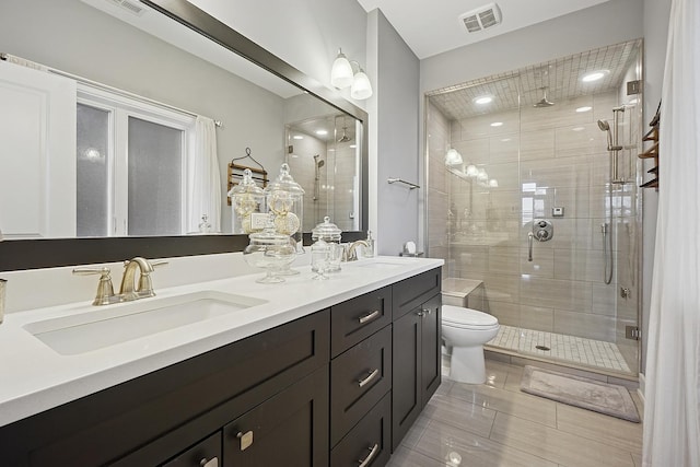 3740 N Kenmore Ave Unit 2, Chicago, IL 60613 - bathroom with a stall shower, double vanity, toilet, and tile patterned floors