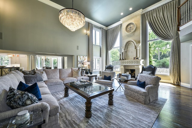 1877 Banbury Rd, Inverness, IL 60067 - living room with ornamental molding, a chandelier, a towering ceiling, a fireplace, and hardwood / wood-style floors