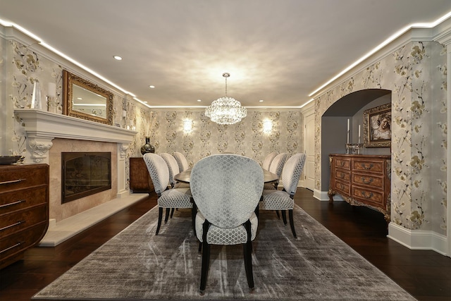 1877 Banbury Rd, Inverness, IL 60067 - dining room with wallpapered walls, arched walkways, dark wood-style flooring, crown molding, and a high end fireplace