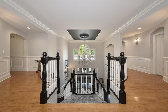 1877 Banbury Rd, Inverness, IL 60067 - stairway with a decorative wall, a chandelier, wood finished floors, crown molding, and a wainscoted wall