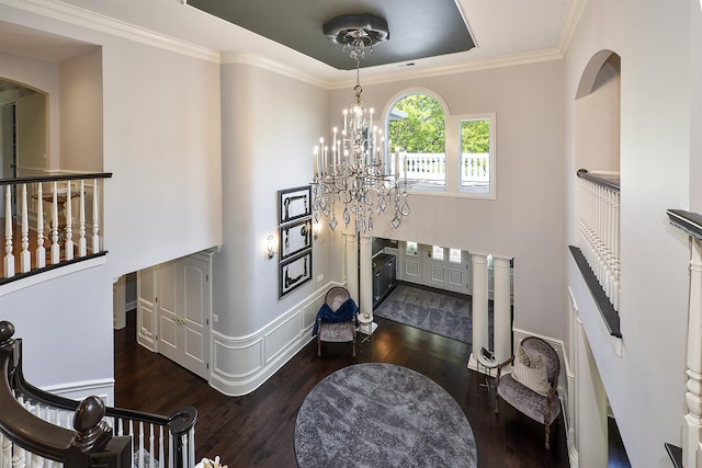1877 Banbury Rd, Inverness, IL 60067 - foyer entrance with dark wood-style floors, a chandelier, ornamental molding, a tray ceiling, and arched walkways