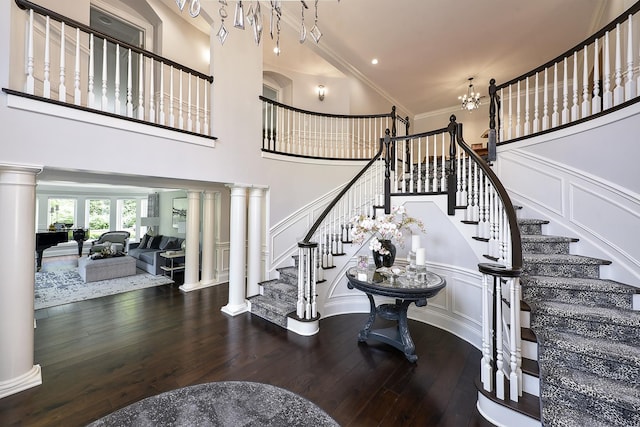 1877 Banbury Rd, Inverness, IL 60067 - staircase featuring a decorative wall, hardwood / wood-style flooring, decorative columns, crown molding, and a towering ceiling