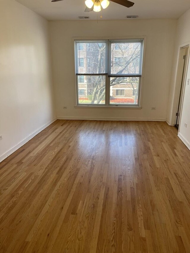 6907 S Cornell Ave, Chicago, IL 60649 - spare room featuring ceiling fan, wood finished floors, and baseboards