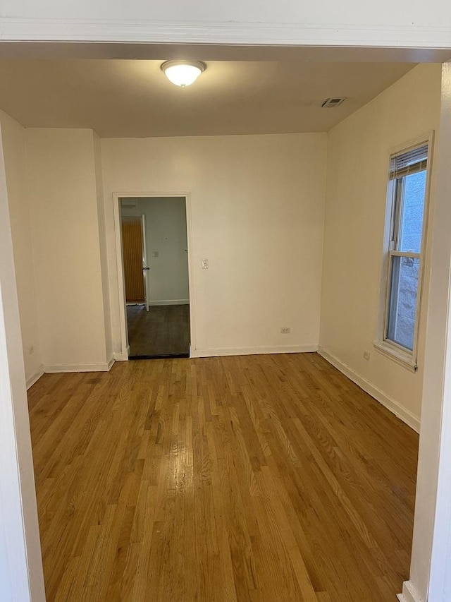 6907 S Cornell Ave, Chicago, IL 60649 - spare room with wood finished floors and baseboards