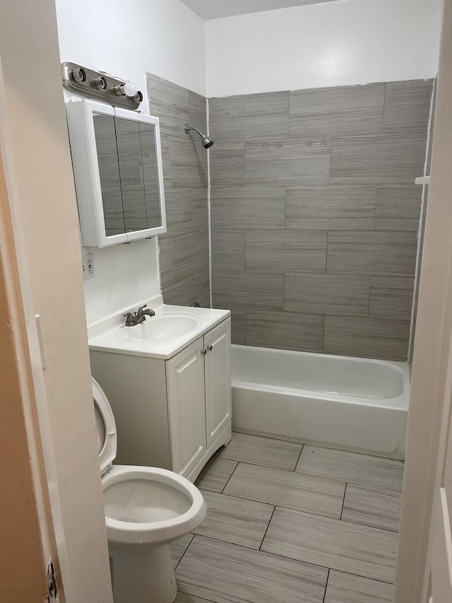 6907 S Cornell Ave, Chicago, IL 60649 - bathroom featuring bathtub / shower combination, toilet, vanity, and tile patterned flooring