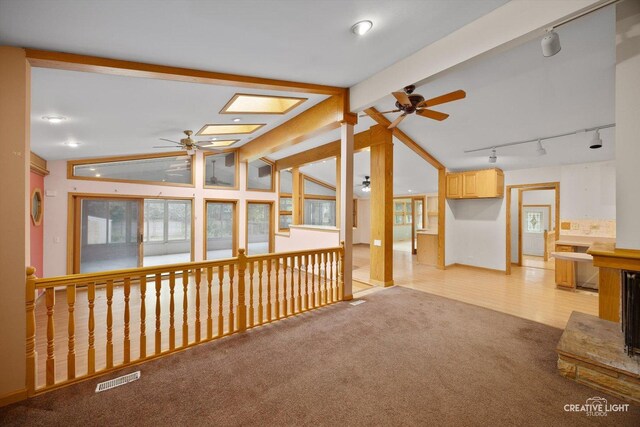 1325 E Lake Ave, Glenview, IL 60025 - unfurnished living room featuring ceiling fan, track lighting, and light carpet