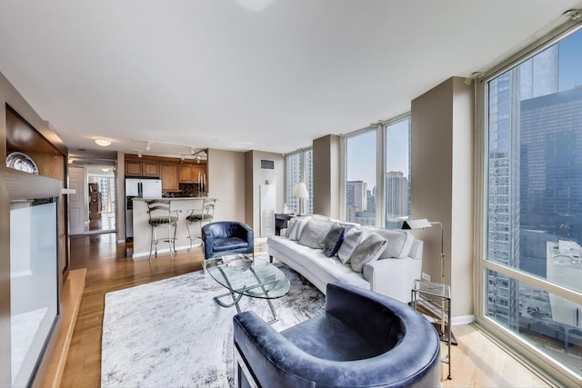 345 N Lasalle Blvd Unit 3904, Chicago, IL 60654 - living area with light wood-style flooring, a wall of windows, track lighting, and a view of city