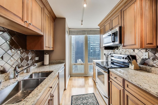 345 N Lasalle Blvd Unit 3904, Chicago, IL 60654 - kitchen with stainless steel appliances, a sink, light wood-style flooring, and light stone countertops