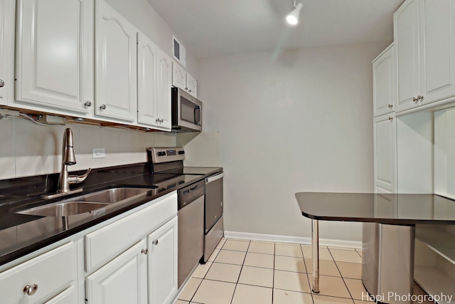 1567 Ridge Ave Unit 401, Evanston, IL 60201 - kitchen with appliances with stainless steel finishes, white cabinetry, and light tile patterned floors