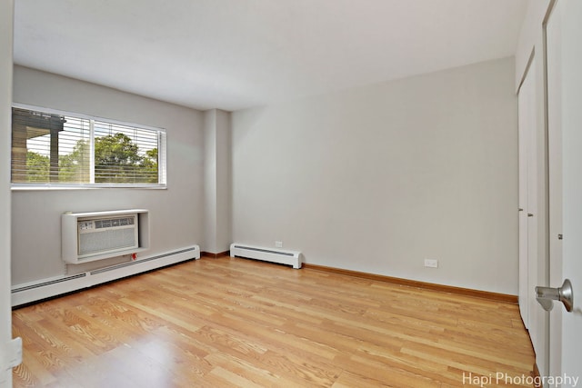 1567 Ridge Ave Unit 401, Evanston, IL 60201 - empty room featuring baseboard heating, a wall unit AC, and wood finished floors