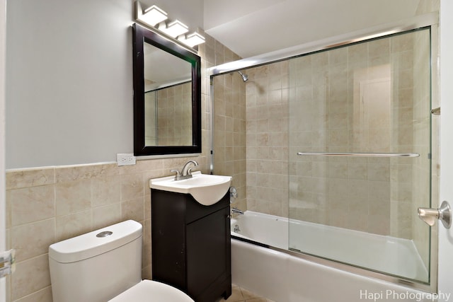 1567 Ridge Ave Unit 401, Evanston, IL 60201 - bathroom with tile walls, vanity, and bath / shower combo with glass door