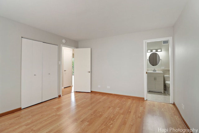 1567 Ridge Ave Unit 401, Evanston, IL 60201 - unfurnished bedroom with light wood finished floors, ensuite bath, and a closet