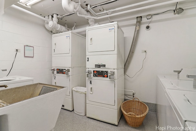 1567 Ridge Ave Unit 401, Evanston, IL 60201 - communal laundry room featuring stacked washer and clothes dryer, concrete block wall, and separate washer and dryer