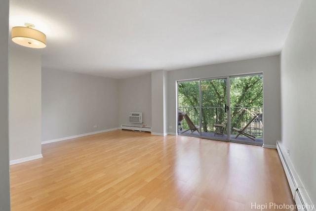 1567 Ridge Ave Unit 401, Evanston, IL 60201 - unfurnished room with a baseboard radiator, light wood-style floors, and an AC wall unit