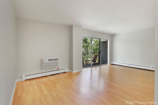 1567 Ridge Ave Unit 401, Evanston, IL 60201 - unfurnished room with a baseboard heating unit, a baseboard radiator, wood finished floors, and a wall mounted air conditioner