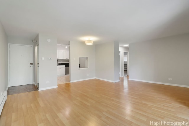 1567 Ridge Ave Unit 401, Evanston, IL 60201 - unfurnished living room with light wood finished floors and baseboard heating