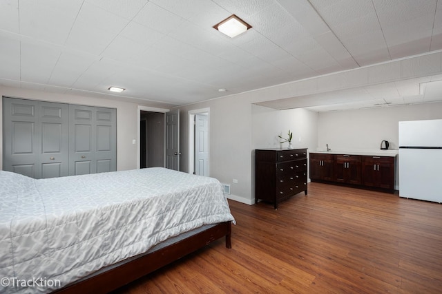 6943 Parkview Dr, Downers Grove, IL 60516 - bedroom featuring freestanding refrigerator, wood finished floors, and a closet