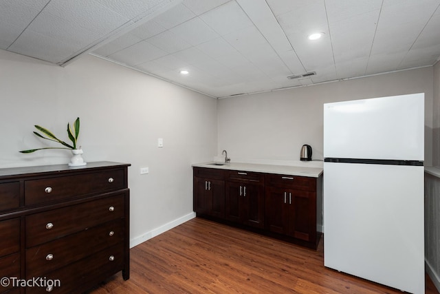 6943 Parkview Dr, Downers Grove, IL 60516 - kitchen with freestanding refrigerator, wood finished floors, dark brown cabinetry, recessed lighting, and light countertops