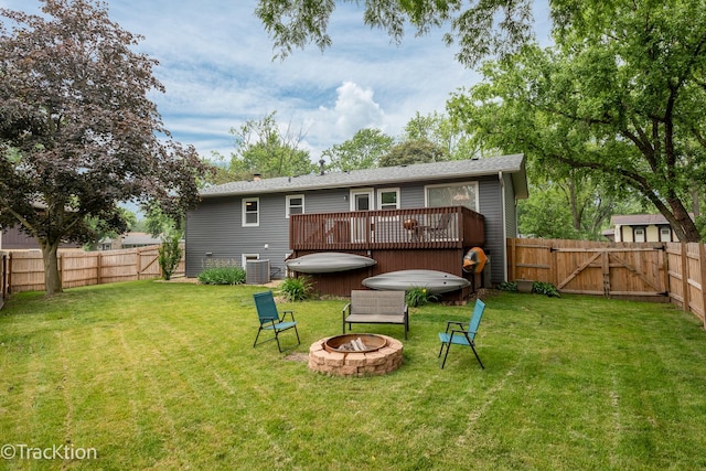 6943 Parkview Dr, Downers Grove, IL 60516 - rear view of property featuring a jacuzzi, an outdoor fire pit, a fenced backyard, and a deck