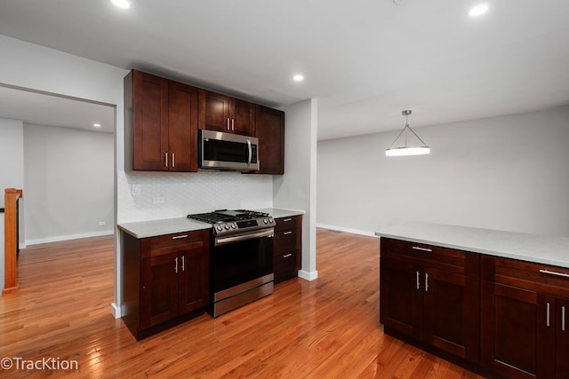 6943 Parkview Dr, Downers Grove, IL 60516 - kitchen featuring stainless steel appliances, light wood-type flooring, light countertops, recessed lighting, and decorative backsplash
