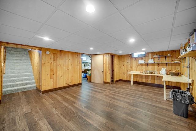 370 N Commonwealth Ave, Elgin, IL 60123 - below grade area featuring baseboards, wood finished floors, stairway, wooden walls, and a drop ceiling