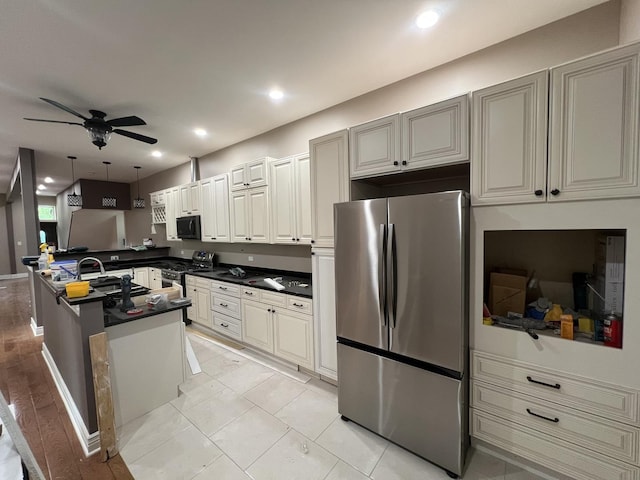 5757 S Aberdeen St, Chicago, IL 60621 - kitchen with appliances with stainless steel finishes, dark countertops, a ceiling fan, a peninsula, and recessed lighting