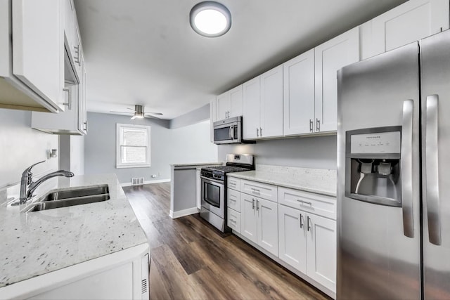 4118 Prairie Ave, Brookfield, IL 60513 - kitchen featuring appliances with stainless steel finishes, ceiling fan, white cabinetry, and light stone countertops