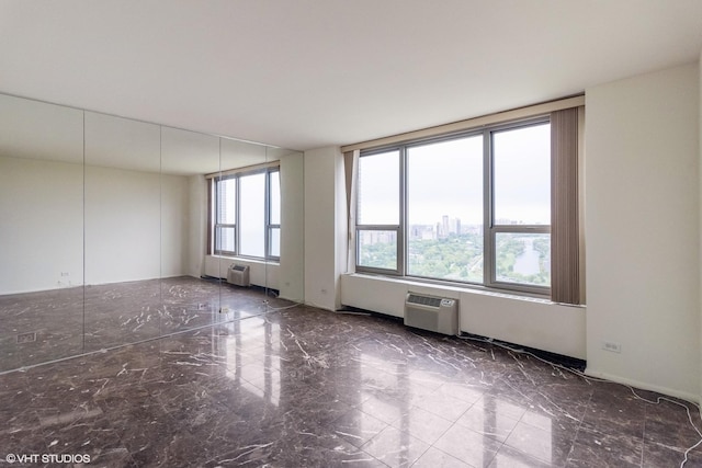 1550 N Lake Shore Dr Unit 32C, Chicago, IL 60610 - empty room with marble finish flooring, an AC wall unit, and a wall mounted AC