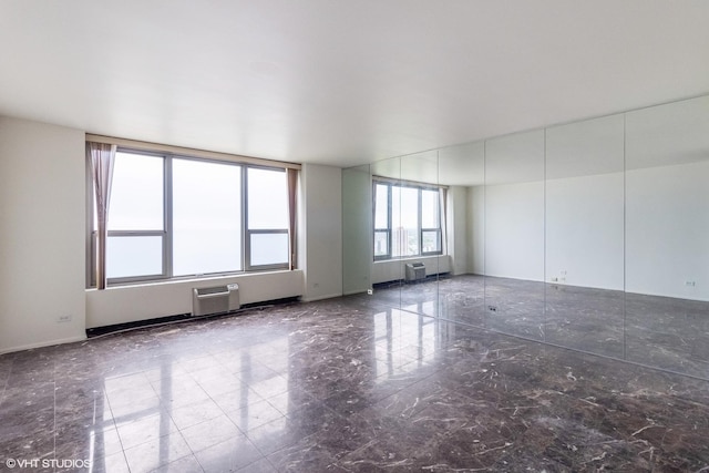1550 N Lake Shore Dr Unit 32C, Chicago, IL 60610 - unfurnished room with a wall unit AC and marble finish floors