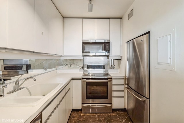 1550 N Lake Shore Dr Unit 32C, Chicago, IL 60610 - kitchen featuring stainless steel appliances, a sink, light countertops, and white cabinets
