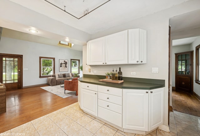 1800 Shermer Rd, Northbrook, IL 60062 - kitchen with dark countertops, light wood-type flooring, white cabinetry, and open floor plan