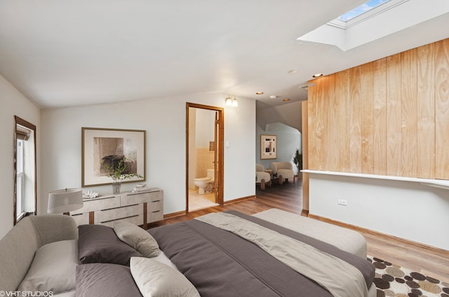 1800 Shermer Rd, Northbrook, IL 60062 - bedroom with vaulted ceiling, a skylight, wood finished floors, and ensuite bath